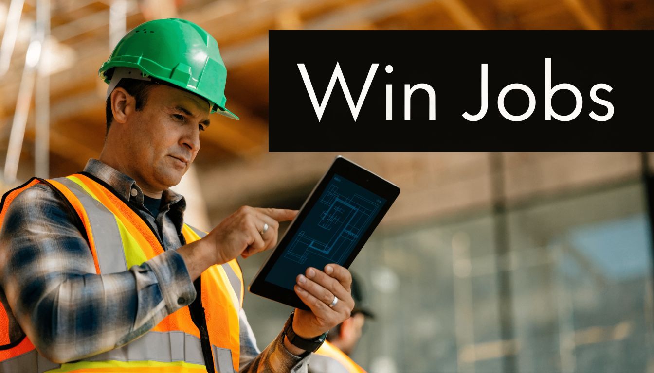 A construction worker in a hard hat and safety vest reviewing blueprints on a digital tablet.